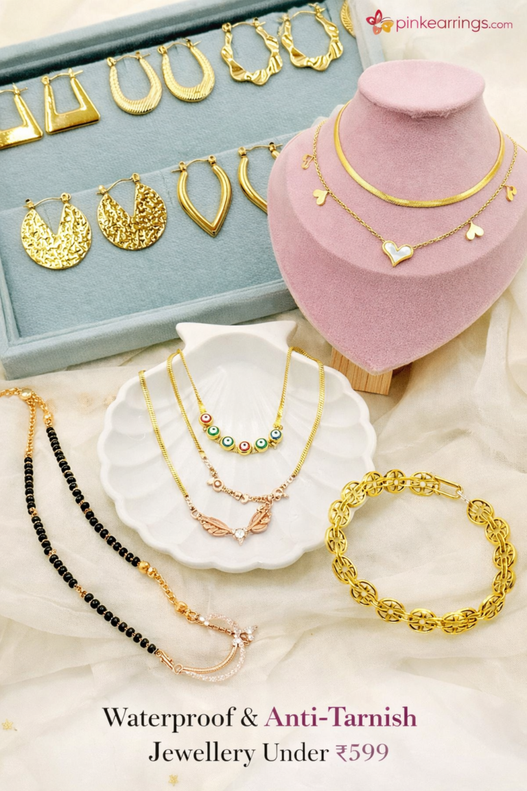 Waterproof and anti-tarnish gold-tone jewellery collection featuring hoop earrings, drop earrings, statement earrings, layered necklaces, evil eye necklace, mangalsutra, bracelet, and golden chains displayed on elegant fabric and velvet stands from PinkEarrings.com