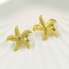 Coastal-inspired gold starfish and pearl stud earrings, perfect for beachwear and tropical vacations