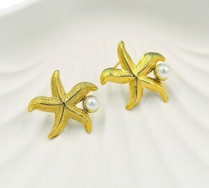 Coastal-inspired gold starfish and pearl stud earrings, perfect for beachwear and tropical vacations