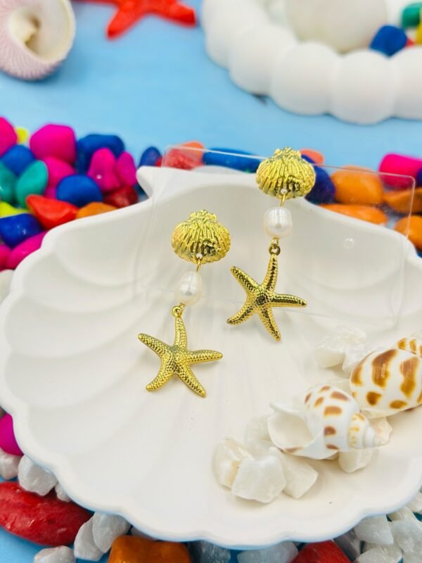 Coastal-inspired gold starfish and pearl long earrings, perfect for beachwear and tropical vacations.
