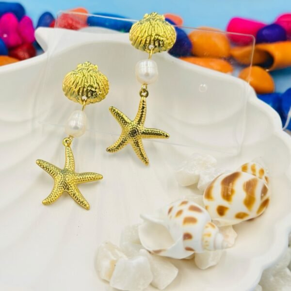 Coastal-inspired gold starfish and pearl long earrings, perfect for beachwear and tropical vacations.