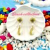 Stylish beachwear jewelry featuring a delicate multiple  shell, natural pearl, and coral charm