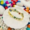 Add a pop of color and love to your wrist with this gold bracelet featuring vibrant multi-colour heart-shaped diamonds