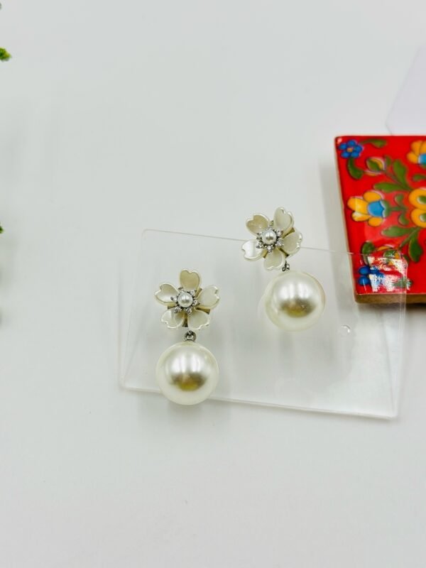 Elegant silver color drop earrings with a lustrous pearl finish