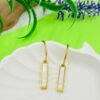 Square-shaped drop earrings in golden and white tones