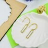 Square-shaped drop earrings in golden and white tones