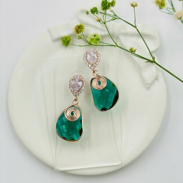 Contemporary-shaped earrings featuring colorful accents and diamonds