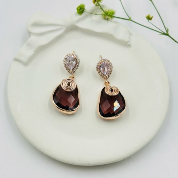 Contemporary-shaped earrings featuring colorful accents and diamonds