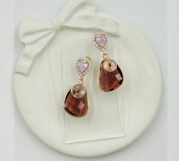 Contemporary-shaped earrings featuring colorful accents and diamonds