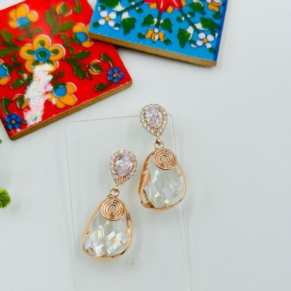 Contemporary-shaped earrings featuring colorful accents and diamonds