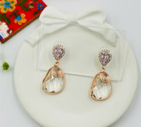Contemporary-shaped earrings featuring colorful accents and diamonds