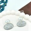 Oval drop earrings featuring dazzling diamonds and a radiant pearl