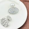 Oval drop earrings featuring dazzling diamonds and a radiant pearl